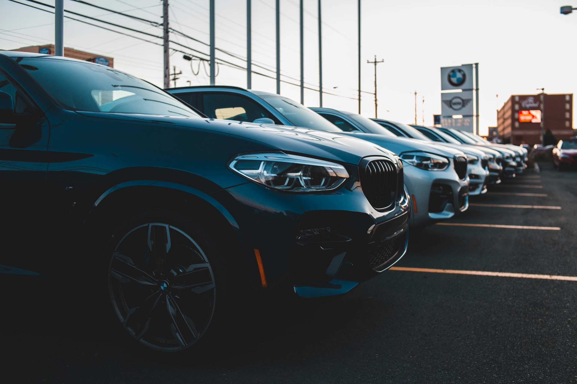 A row of premium SUVs on a CarsHaven dealership forecourt at sunset.